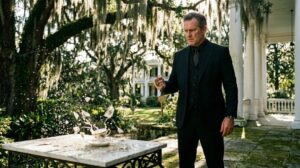 Time stretched into brittle, razor-sharp filaments. Marcus Vance caught the subtle refraction of sunlight off the distant Spanish moss—a needle of silver blinking two hundred yards out in the cypress canopy across the lawn. His reflexes acted before his conscious mind registered the threat. He loosened his grip on the bone-china teacup, dropped his shoulder, and drove the heel of his combat boot into the carved edge of the granite garden table.